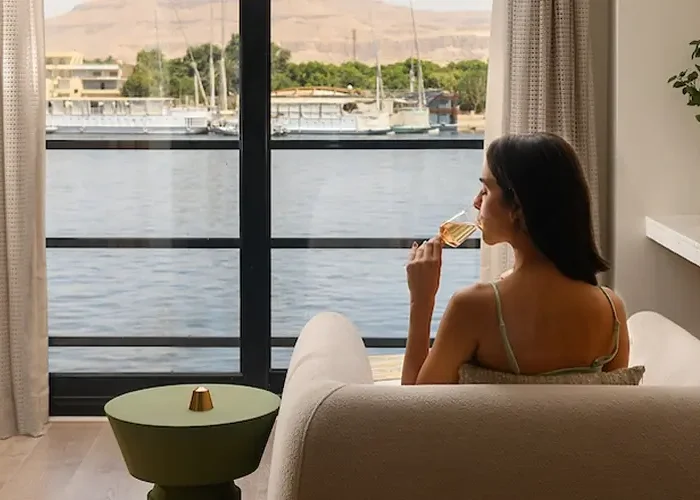 Woman enjoying luxury cruise room with elegant decor