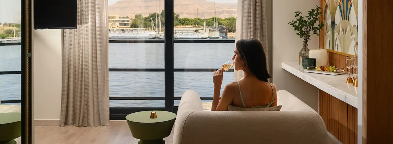 Woman enjoying luxury cruise room with elegant decor