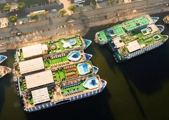 A group of Nile cruise ships lined up on the river.