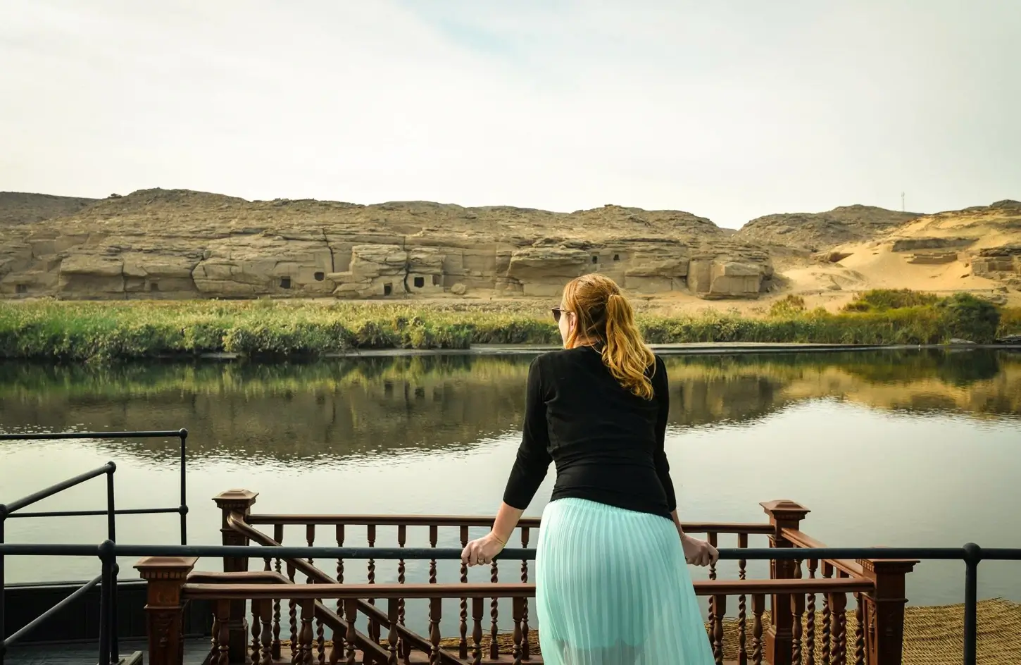 A stunning photo of a tourist standing on a Dahabiya