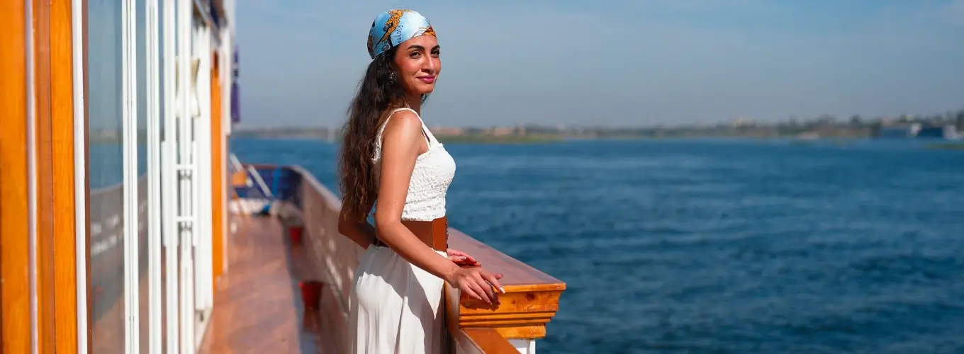 Beautiful woman enjoying the view from a cruise ship deck.