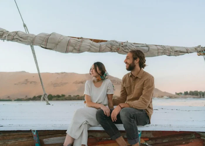 Couple enjoying a romantic ride on a felucca on the Nile River in Luxor.