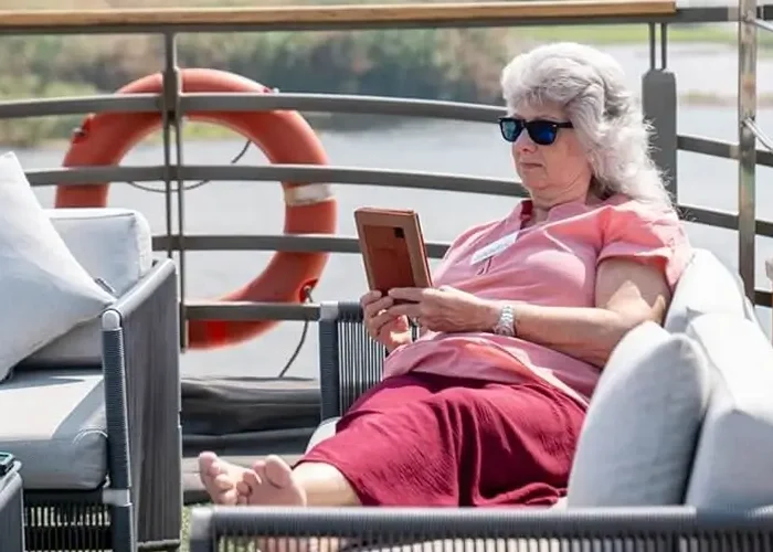 A woman enjoying the view from a cruise ship roof.