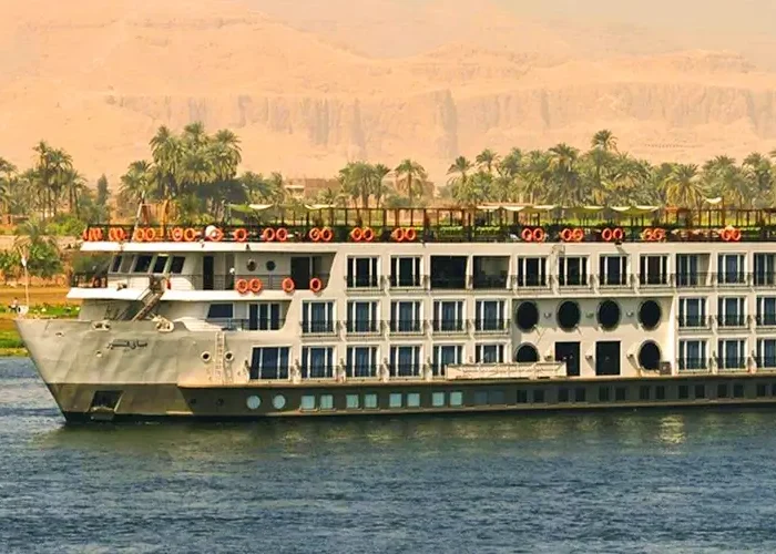 A scenic cruise alongside a traditional felucca on the Nile River.