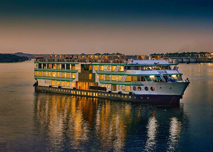 Luxury cruise ship Acamar at sunset on the ocean.