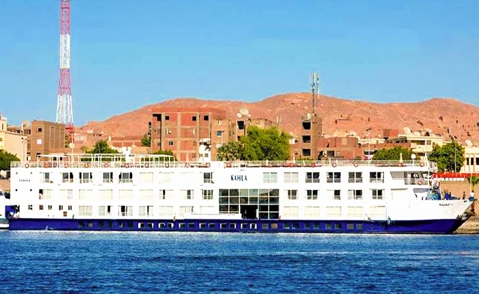 Al-Kahila Cruise boat sailing on clear waters with scenic views.