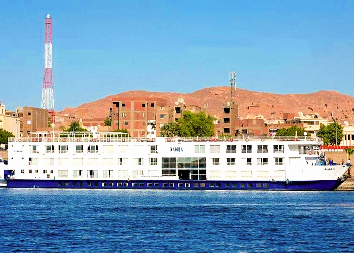 Al-Kahila Cruise boat sailing on clear waters with scenic views.