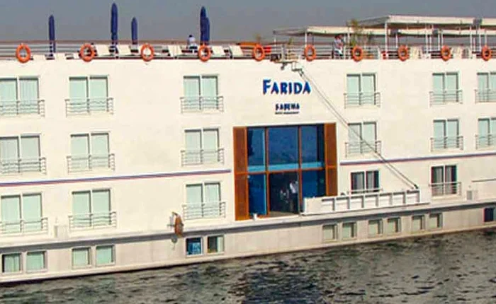 A scenic view of the Farida Cruise on the water during sunset.