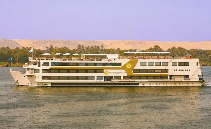 Elegant cruise ship named Goddess-Cruise sailing on tranquil waters.