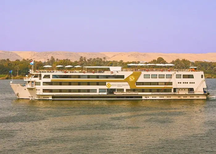 Elegant cruise ship named Goddess-Cruise sailing on tranquil waters.