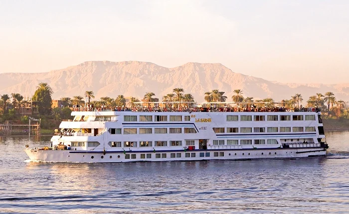 Luxury cruise boat on the Nile River in Egypt with scenic views.