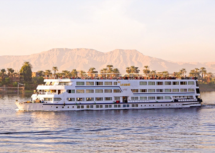 Luxury cruise boat on the Nile River in Egypt with scenic views.