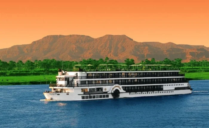 Luxurious MS Esplanade cruise ship on the Nile River at sunset.