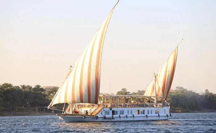 Luxurious Dahabiya sailing on the Nile River during sunset