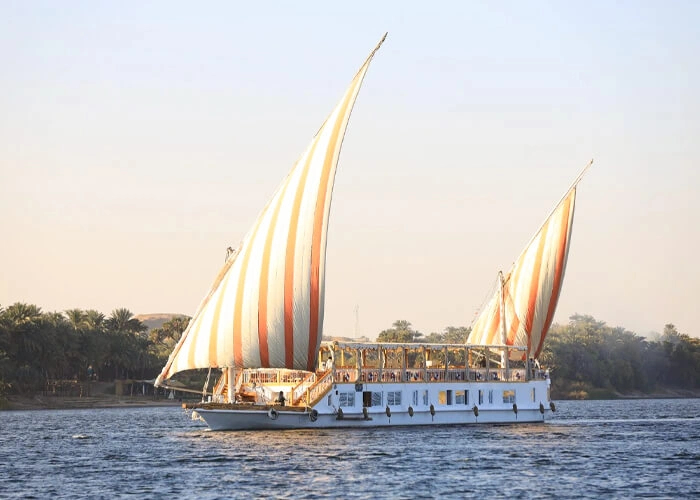 Luxurious Dahabiya sailing on the Nile River during sunset