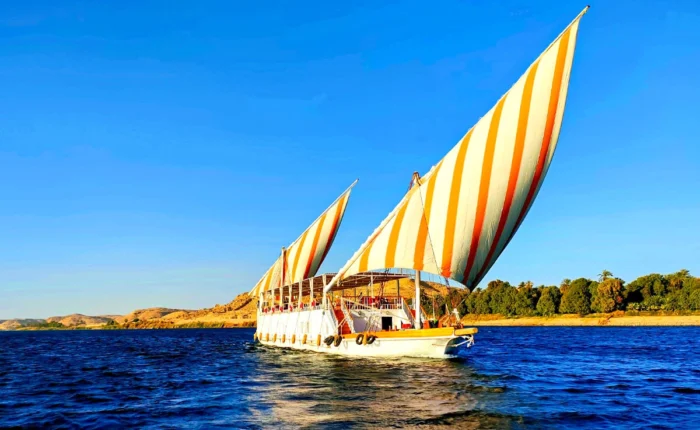 Three pyramids visible from a Dahabiya on the Nile River.