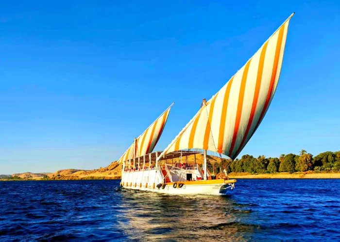 Three pyramids visible from a Dahabiya on the Nile River.
