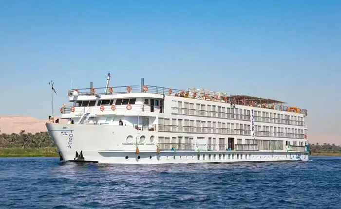 Tosca Cruise ship sailing on the ocean under a clear blue sky