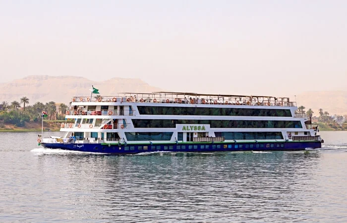 Alyssa smiling on a cruise ship deck under the sun.