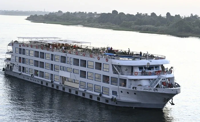 Serenity on a Nile cruise showcasing lush banks and clear waters.