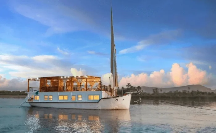 Queen Cleopatra aboard a dahabiya on the Nile River.