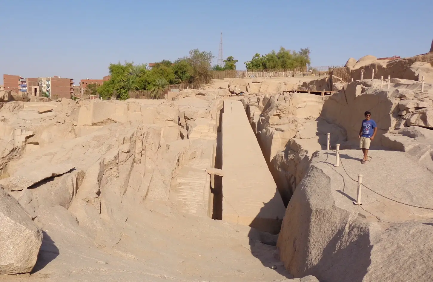 A-stunning-photograph-of-a-person-standing-in-front-of-the-unfinished-obelisk-in-Aswan The Unfinished Obelisk at Aswan: History, Crack & Visit Guide